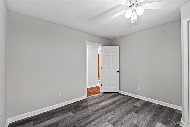 empty room with a textured ceiling, ceiling fan, and dark wood-type flooring