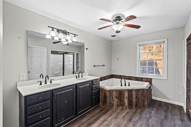 bathroom with vanity, hardwood / wood-style flooring, ceiling fan, and a tub