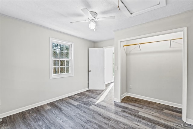 unfurnished bedroom featuring dark hardwood / wood-style flooring, a closet, and ceiling fan