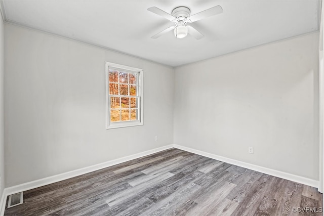 empty room featuring baseboards, visible vents, ceiling fan, and wood finished floors