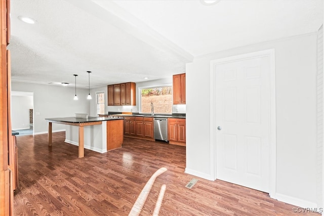 kitchen featuring stainless steel dishwasher, dark hardwood / wood-style floors, decorative light fixtures, a kitchen bar, and a kitchen island