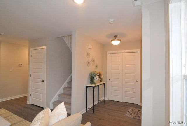 foyer featuring stairs, wood finished floors, visible vents, and baseboards