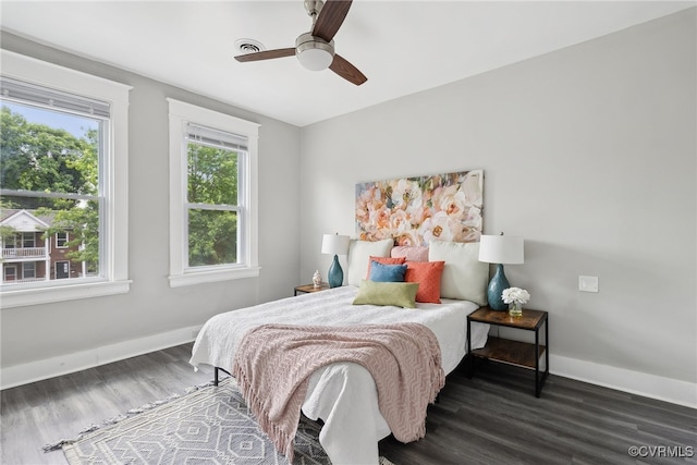 bedroom with ceiling fan and dark hardwood / wood-style flooring