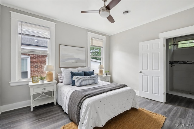 bedroom featuring ornamental molding, multiple windows, dark wood-type flooring, and ceiling fan