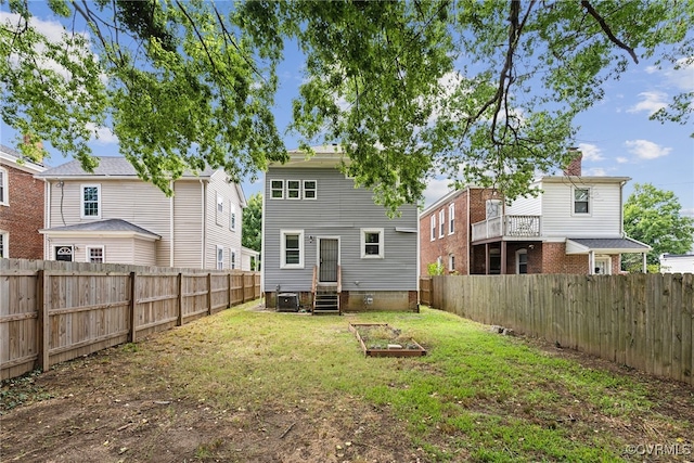 back of house with a lawn and central AC unit