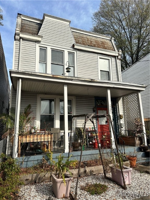 back of property featuring covered porch