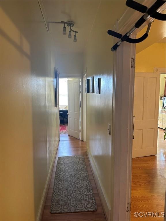 hallway with light hardwood / wood-style floors