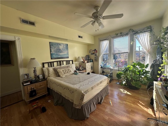 bedroom with hardwood / wood-style floors and ceiling fan