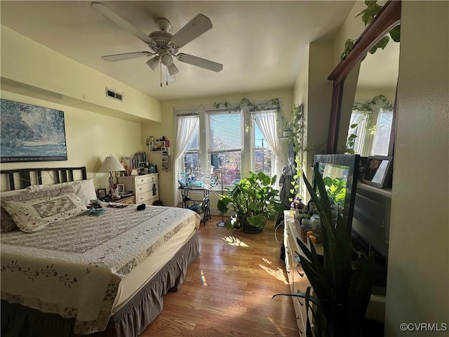 bedroom featuring hardwood / wood-style flooring and ceiling fan