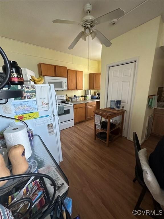 kitchen featuring dark hardwood / wood-style flooring, white appliances, and ceiling fan