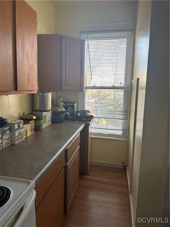 kitchen featuring light wood-type flooring and white range with electric stovetop