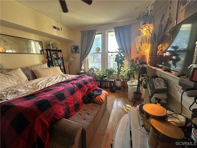 bedroom featuring hardwood / wood-style floors and ceiling fan