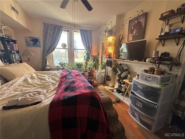 bedroom with wood-type flooring and ceiling fan