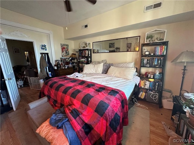 bedroom with ceiling fan and hardwood / wood-style floors