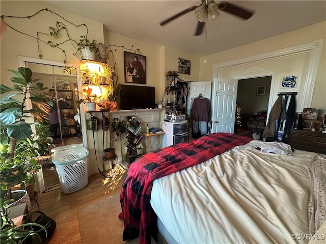 bedroom with ceiling fan and wood-type flooring