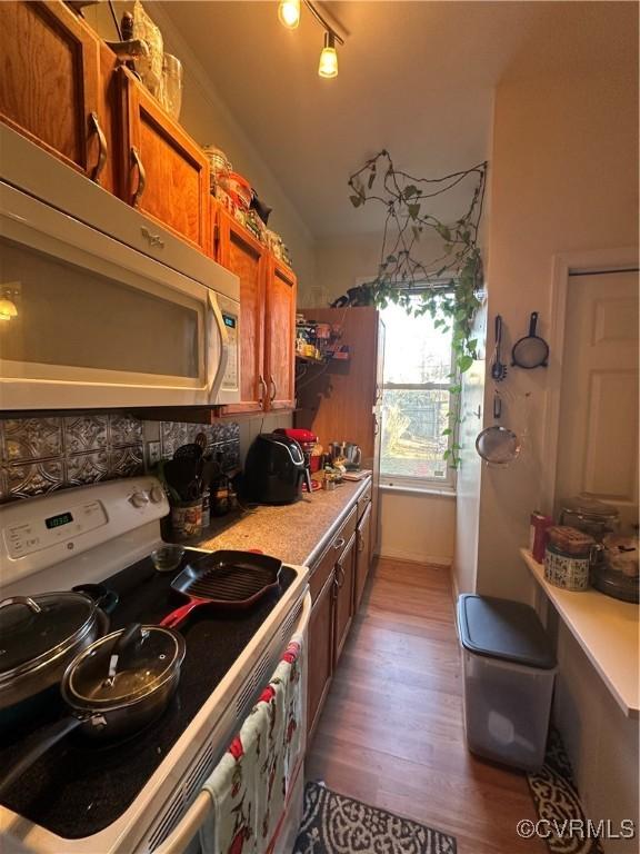 kitchen featuring white range with electric cooktop and hardwood / wood-style flooring