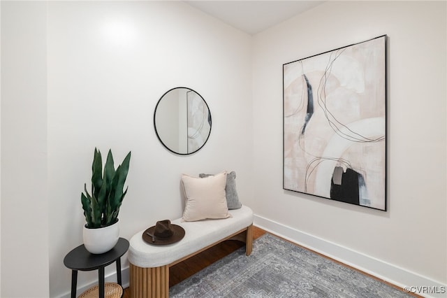 sitting room featuring baseboards and wood finished floors