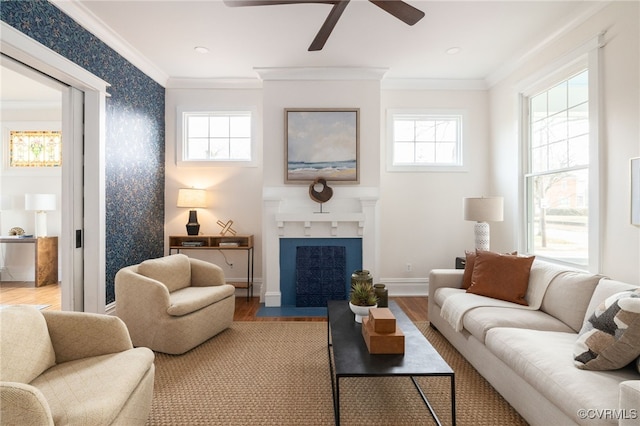 living room featuring ornamental molding, baseboards, a fireplace with flush hearth, and wood finished floors