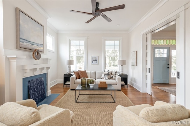 living area featuring ornamental molding, plenty of natural light, and wood finished floors