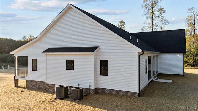 view of side of property with central air condition unit