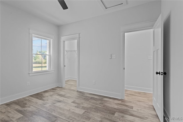 empty room with light wood-type flooring and ceiling fan