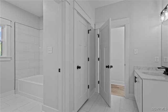 bathroom with tile patterned floors, vanity, and tiled shower / bath combo