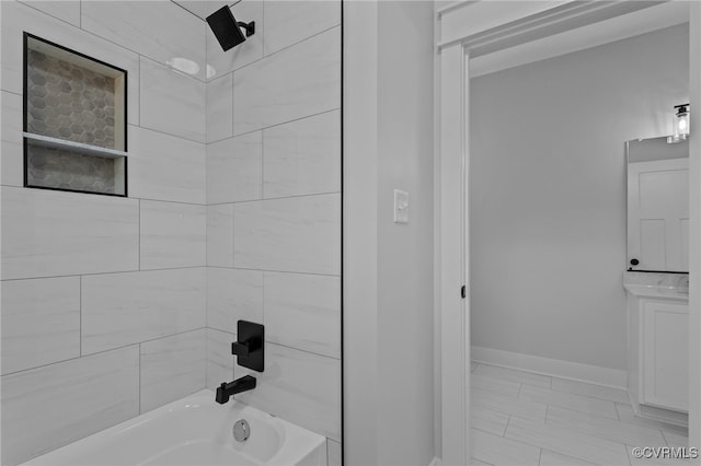 bathroom with vanity and tiled shower / bath combo