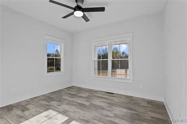 spare room featuring light hardwood / wood-style floors and ceiling fan