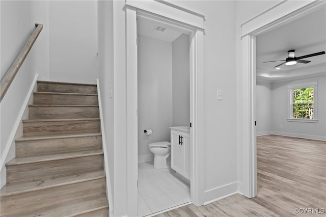 bathroom featuring ceiling fan, toilet, vanity, and hardwood / wood-style flooring