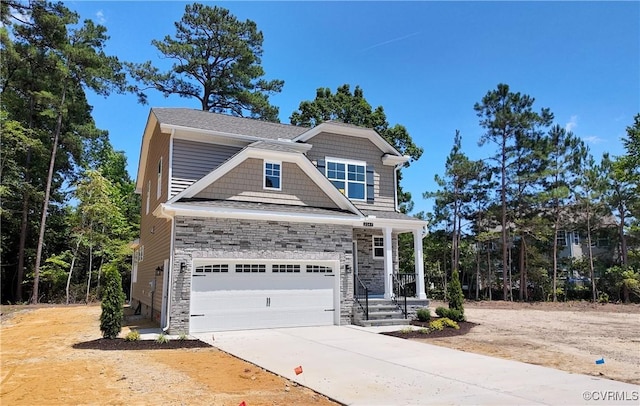 2047 Swiss Ln, Hayes, VA 23072 - view of front of house with concrete driveway, a garage, and stone siding