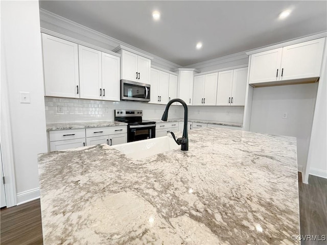 2047 Swiss Ln, Hayes, VA 23072 - kitchen featuring electric range oven, stainless steel microwave, white cabinetry, ornamental molding, and light stone countertops