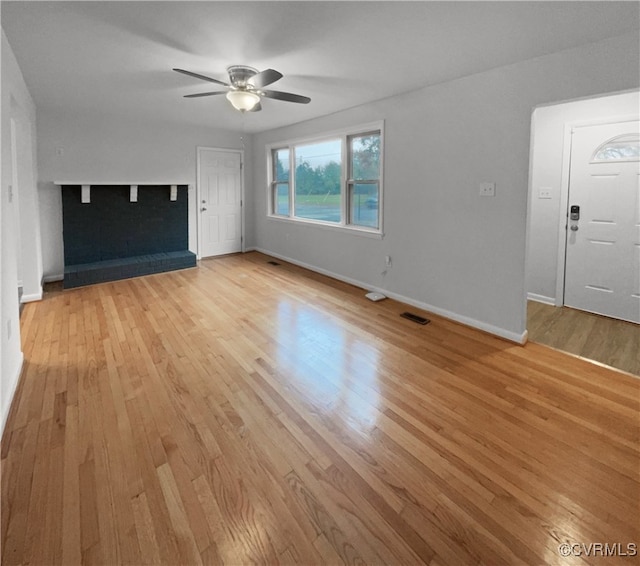 unfurnished living room with light wood-type flooring and ceiling fan