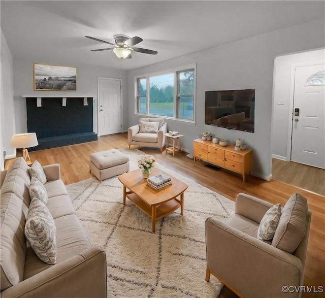 living room featuring hardwood / wood-style flooring and ceiling fan