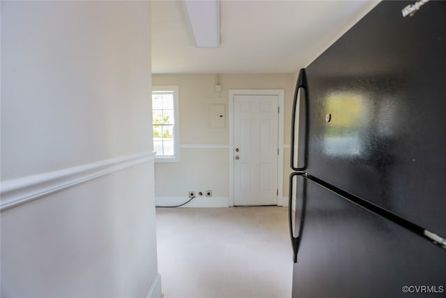 kitchen with black fridge and electric panel