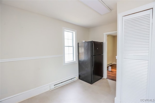 kitchen with black fridge and baseboard heating