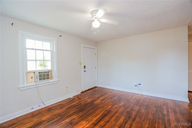 empty room with a textured ceiling, dark hardwood / wood-style floors, and ceiling fan