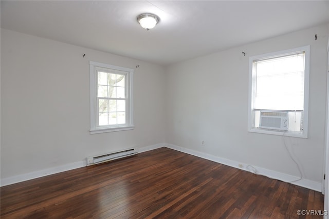 spare room featuring cooling unit, baseboard heating, and dark wood-type flooring