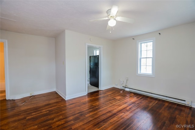 spare room with baseboard heating, ceiling fan, dark hardwood / wood-style flooring, and a textured ceiling