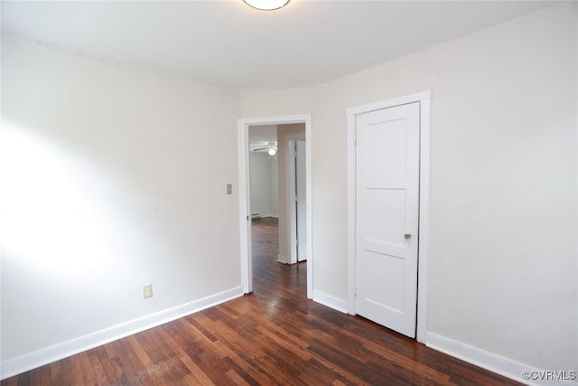 unfurnished room with ceiling fan and dark hardwood / wood-style flooring