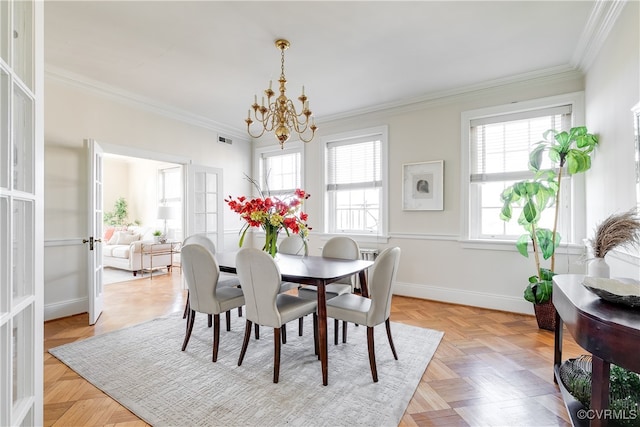 dining room with crown molding, french doors, light parquet flooring, and a notable chandelier