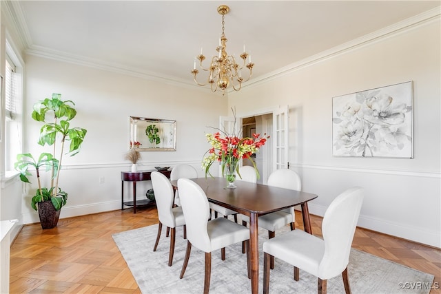 dining area featuring a chandelier, light parquet flooring, and crown molding