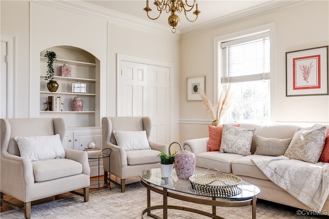 living room featuring built in shelves, hardwood / wood-style floors, ornamental molding, and an inviting chandelier