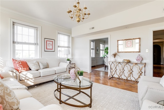 living room with parquet floors, crown molding, radiator, and an inviting chandelier