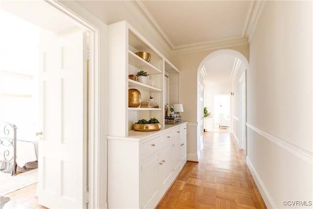 corridor featuring crown molding and light parquet flooring