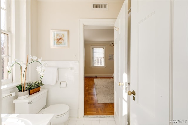 bathroom with toilet and parquet flooring