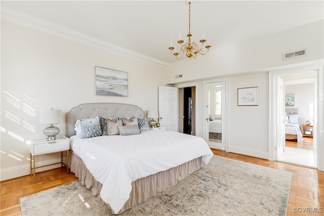 bedroom featuring a chandelier, light parquet flooring, and crown molding