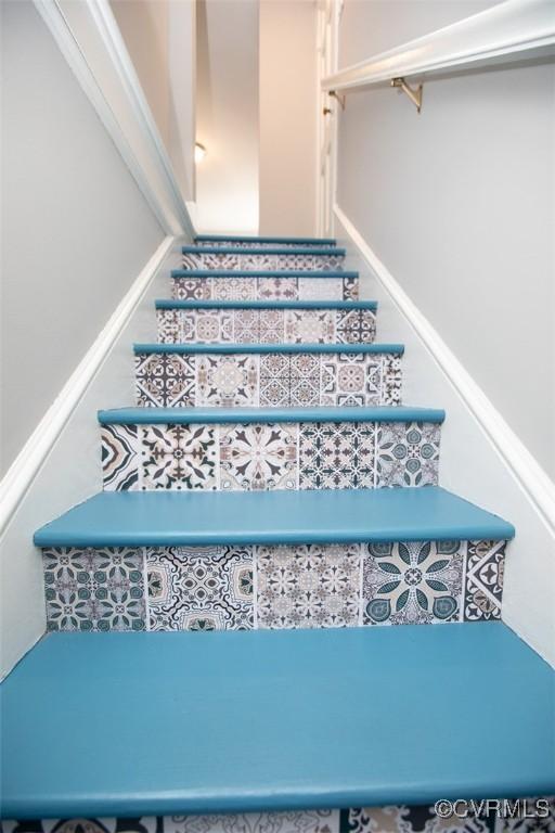 staircase featuring ornamental molding