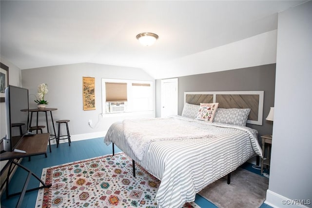 bedroom featuring cooling unit, wood-type flooring, and vaulted ceiling