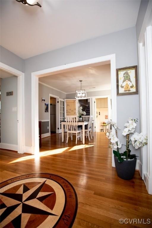 interior space featuring an inviting chandelier and hardwood / wood-style flooring