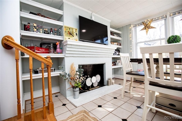 tiled bedroom featuring a fireplace and ornamental molding